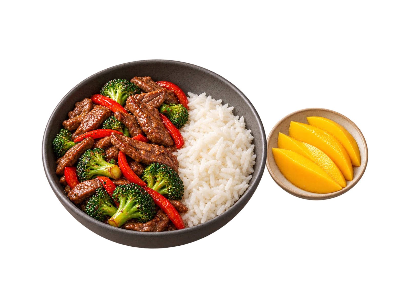 A charcoal bowl of beef and broccoli stir-fry with red pepper strips and jasmine rice, mango slices on a side plate.